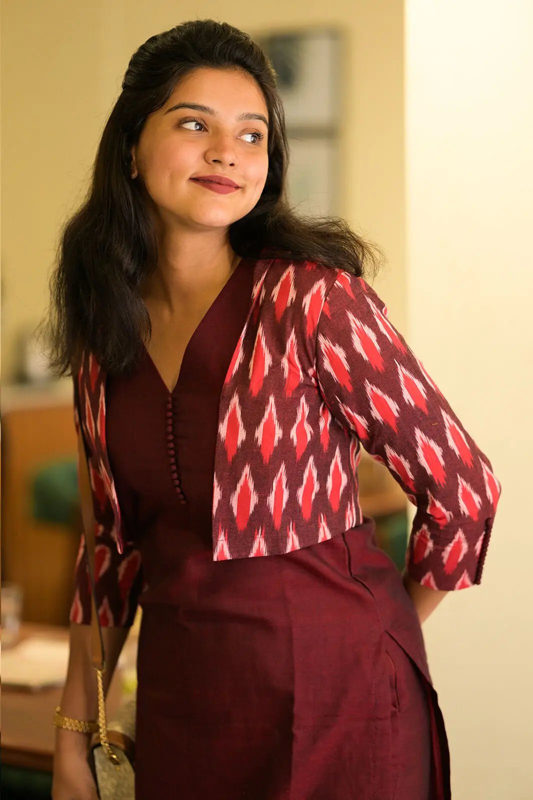 Model wearing maroon kurta jacket set, side view