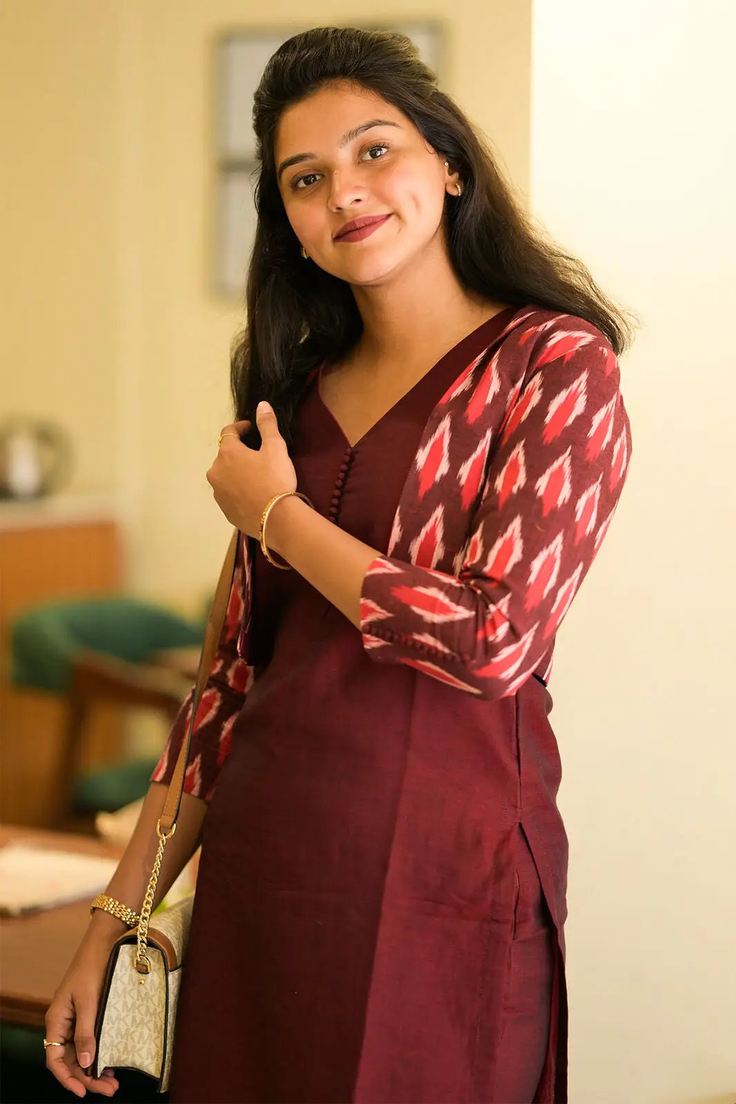 Model in maroon kurta set with handbag