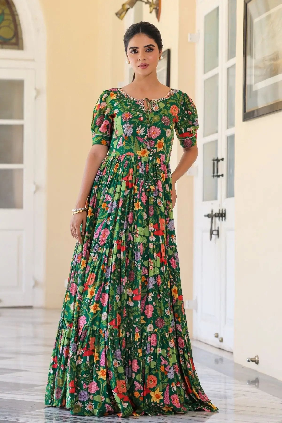 Front view of Titli Maxi in Green featuring a floral design, puff sleeves, and a pleated maxi style for a graceful ethnic outfit.