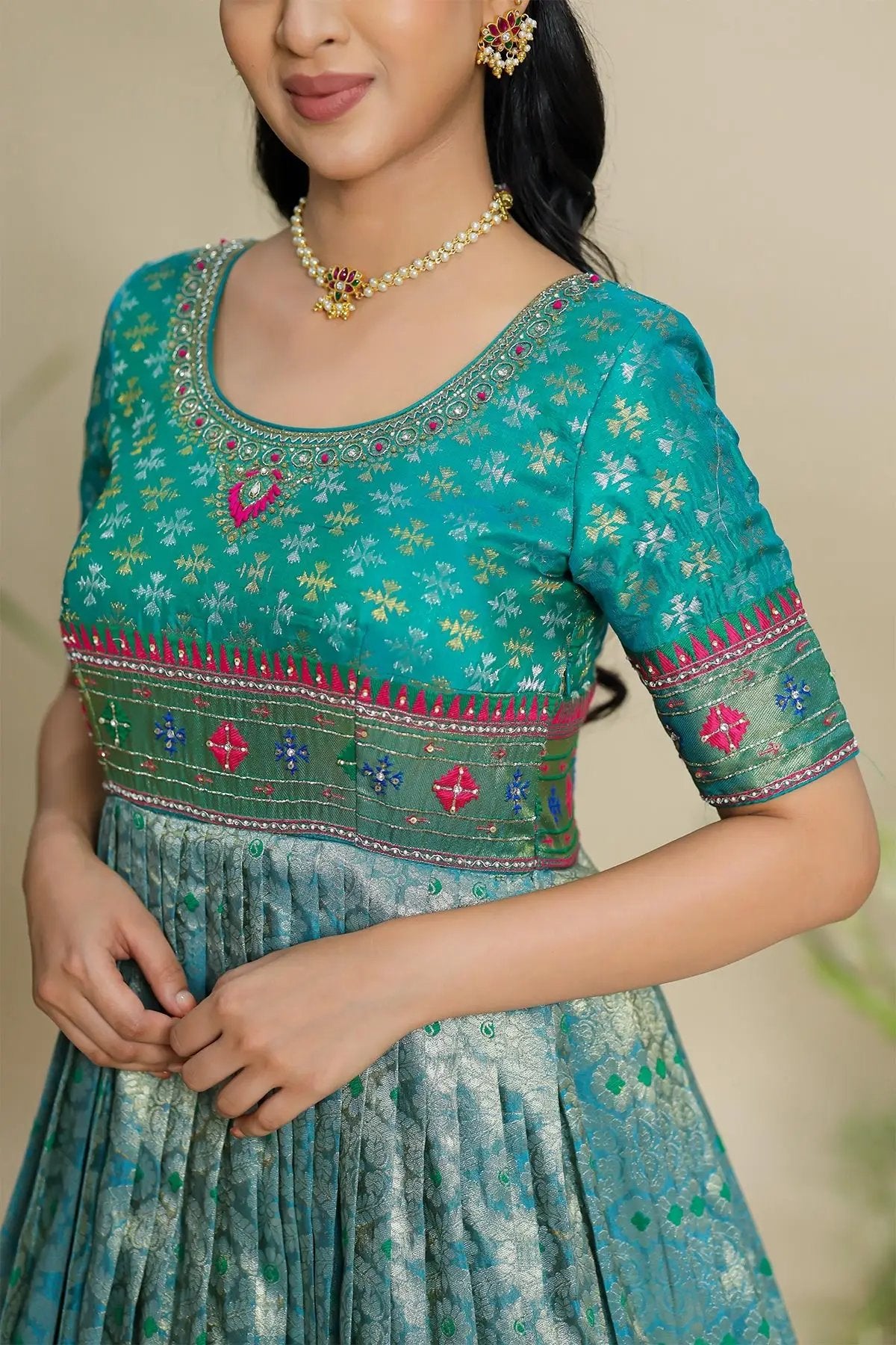 a woman in turquoise Jyoti Patola Zari Dress - Bullionknot