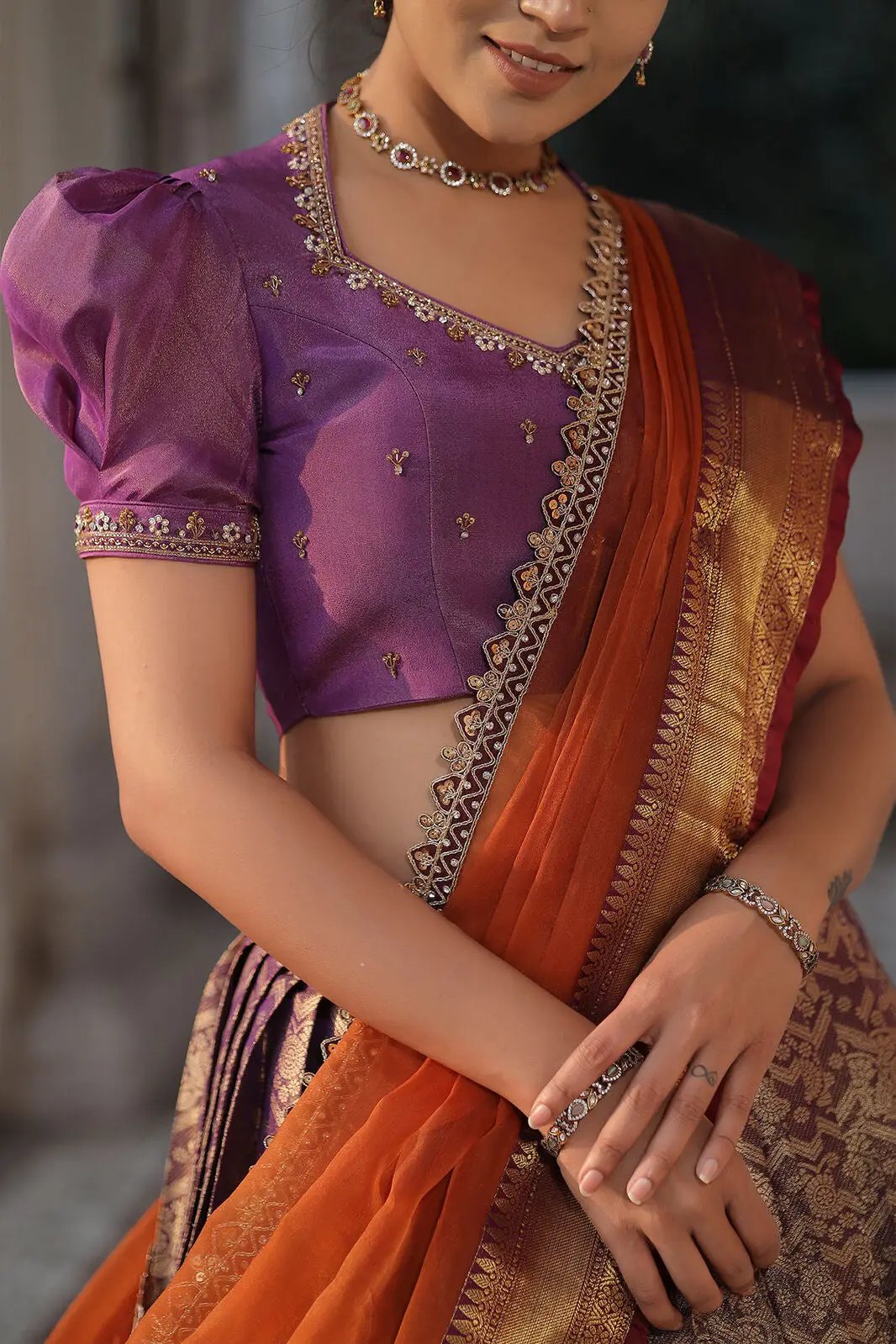 Close-up of lavender blouse with orange dupatta in lehenga set