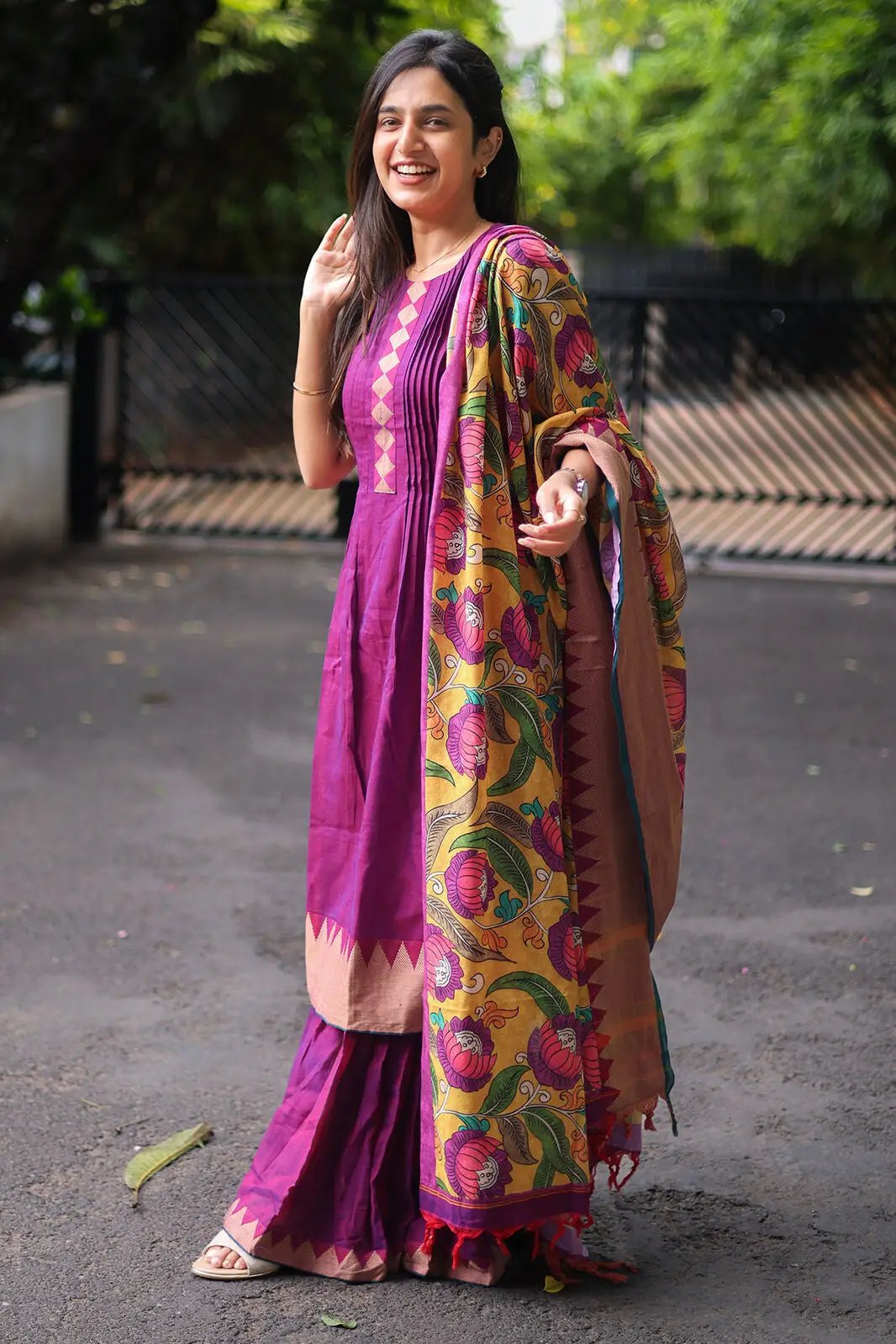 Model in purple sharara set, showcasing vibrant dupatta