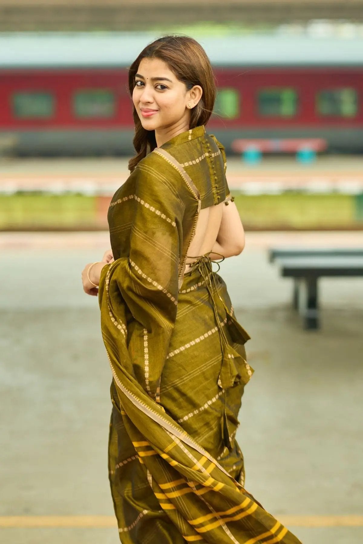 Back view of Madhvi Handloom Saree in Mehndi, highlighting its intricate patterns and elegant drape. Ideal for traditional celebrations.