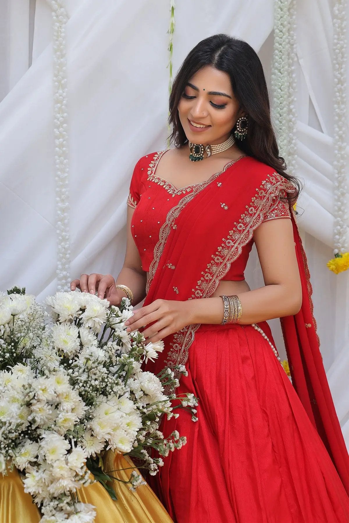 a woman in red half saree