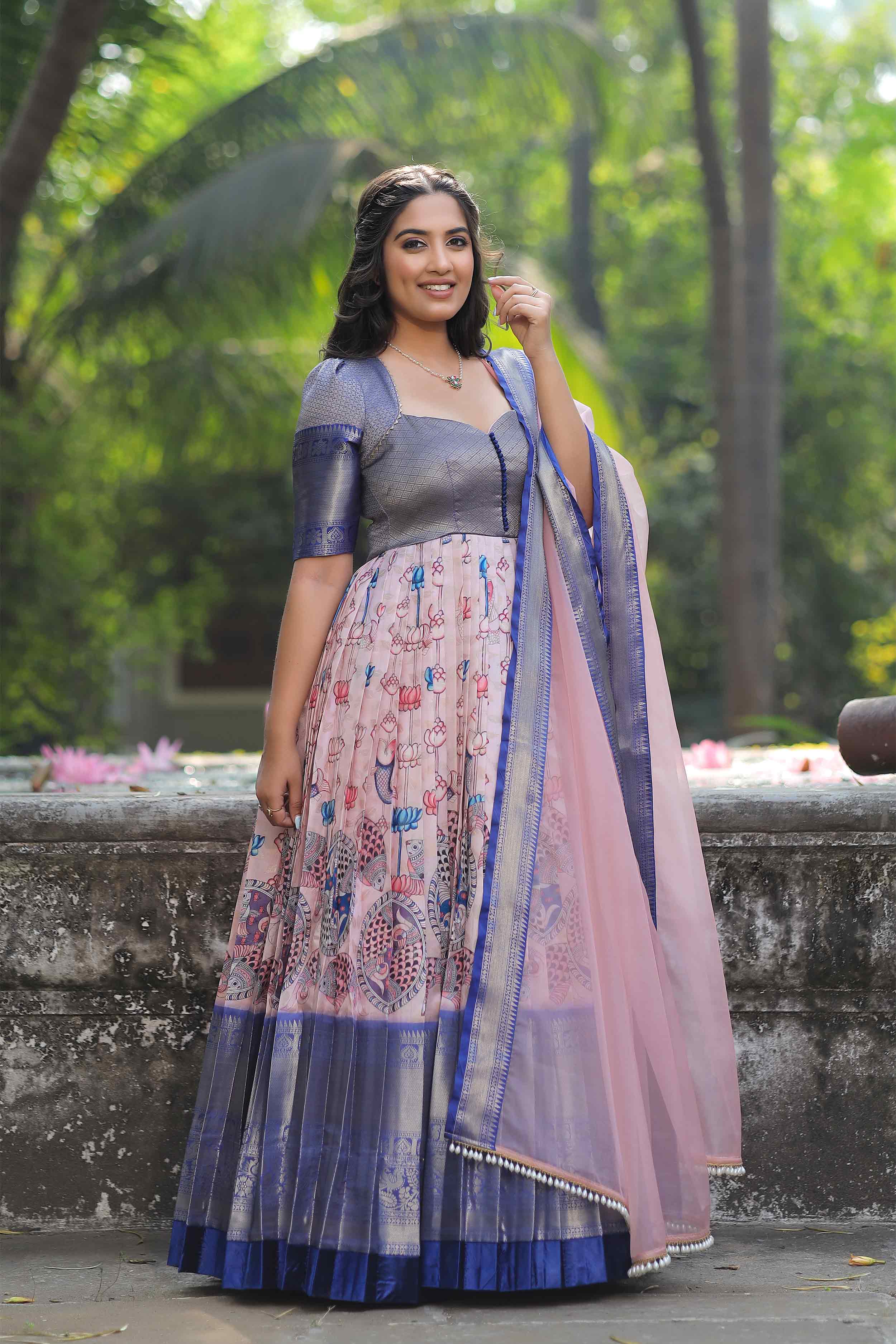 a woman in a long dress posing for a picture