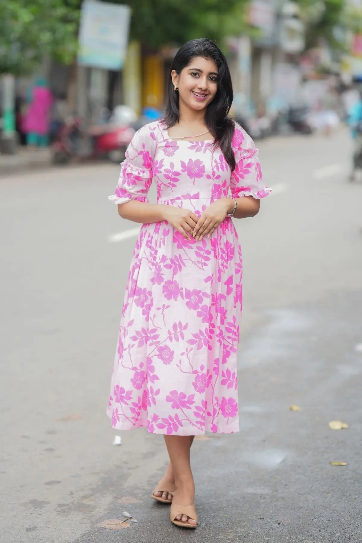 Front view of the Polly Midi Dress in pink, featuring a floral pattern and comfortable midi length for everyday wear.