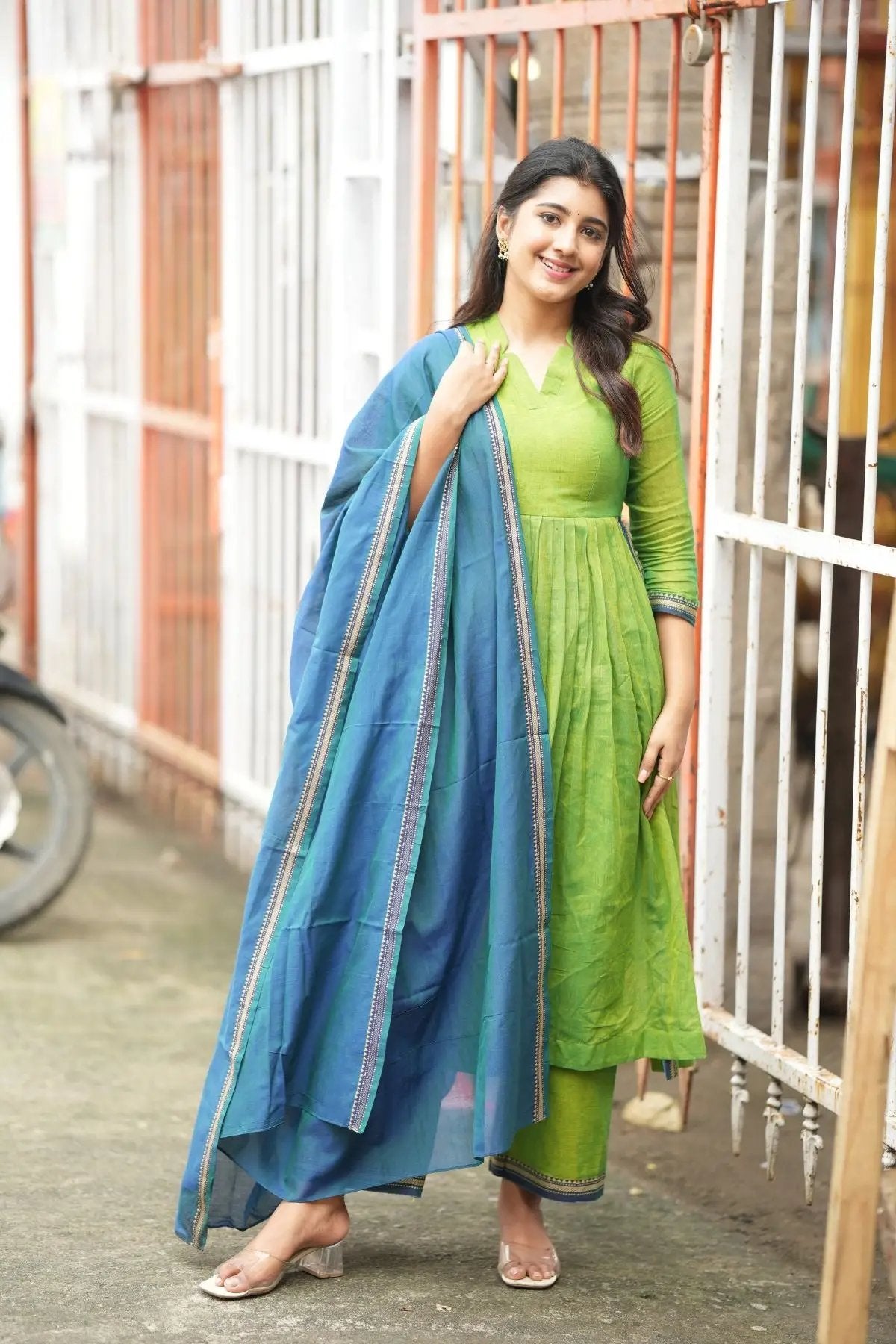 Punaam Kurta Set in green with a vibrant blue dupatta, featuring intricate border detailing and a flattering fit.