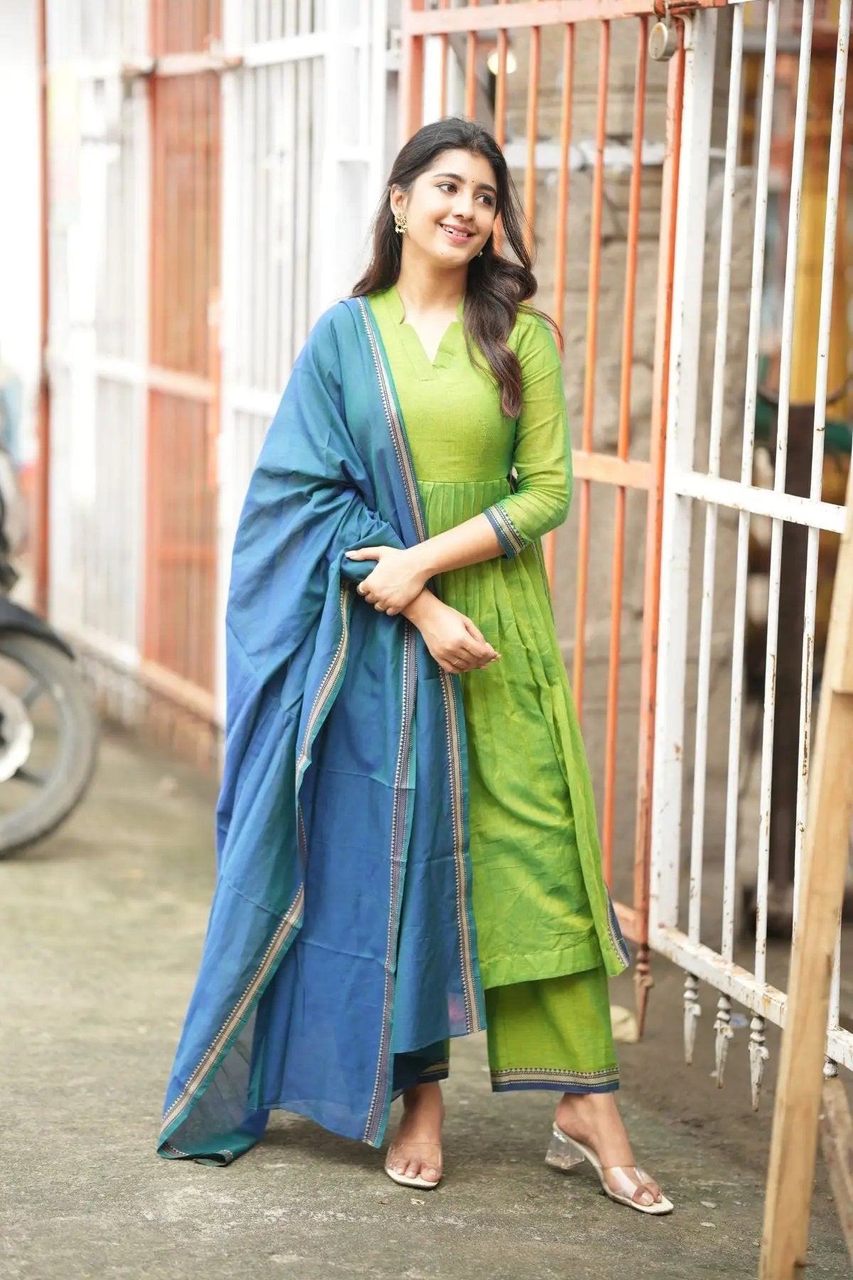 Stylish Punaam Kurta Set in green with a flowy blue dupatta, designed for comfort and elegance in traditional attire.