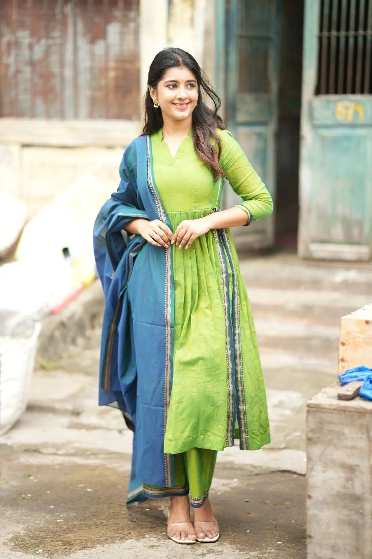 Punaam Kurta Set in green with pleated design, paired with a contrasting blue dupatta featuring intricate border details.