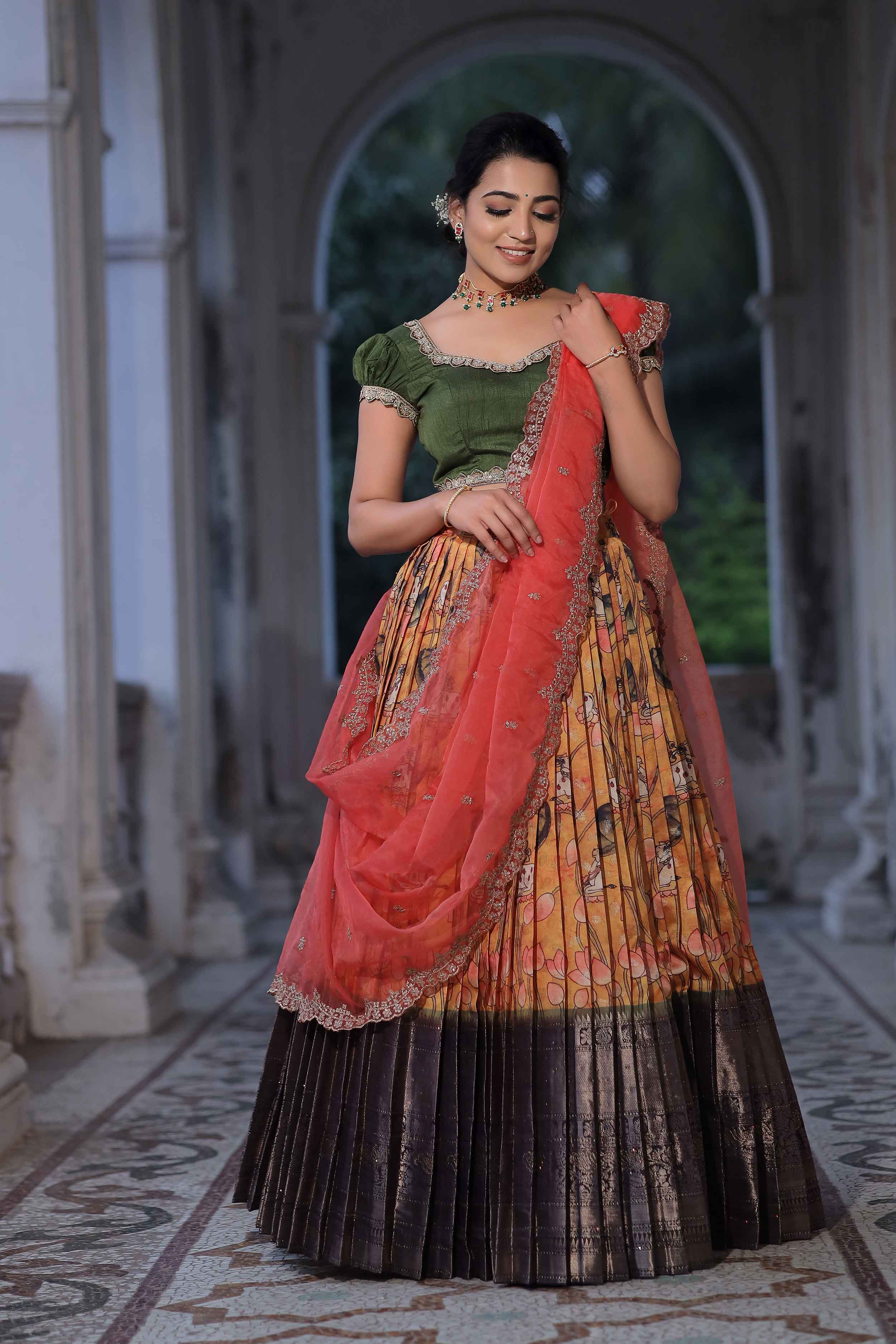 a woman in mehndi green banarasi suit