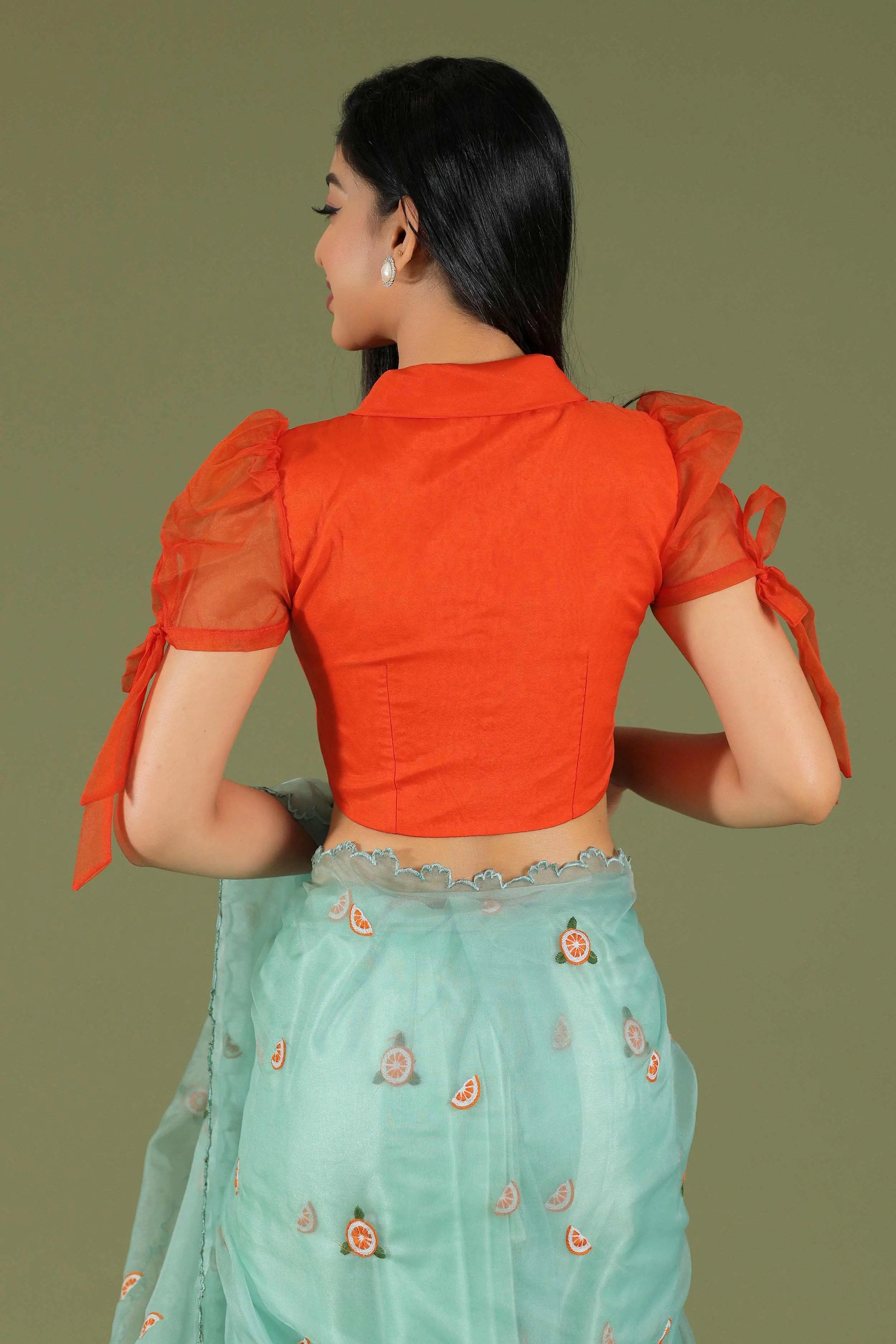 Orange blouse with puff sleeves and turquoise saree