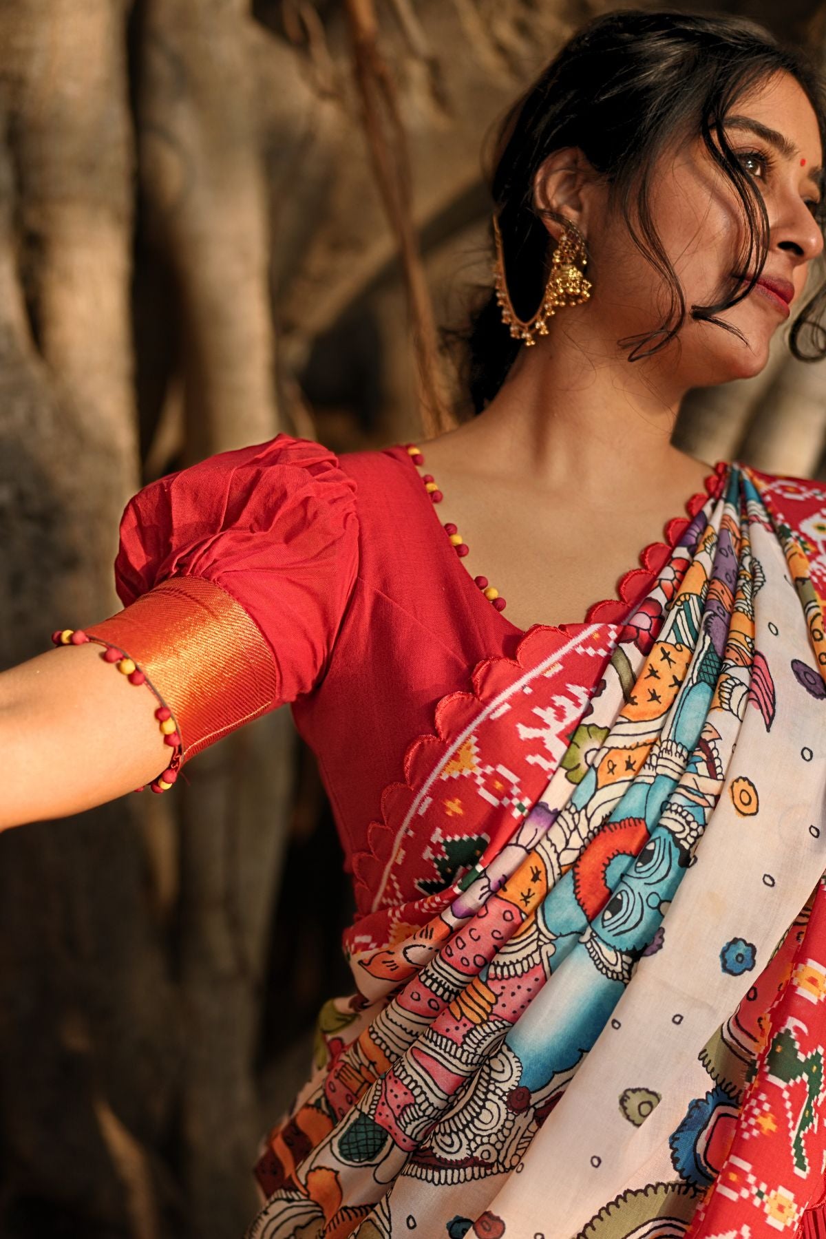 Close-up of the Revti Handloom Lehenga Set in Red showcasing detailed embroidery and vibrant patterns on the dupatta.