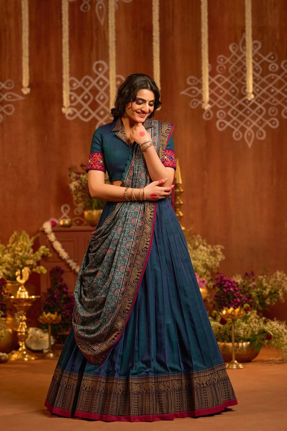 Exclusive Rudram Lehenga Set in peacock blue with intricate embroidery, pleated skirt, and elegant dupatta, perfect for traditional occasions.