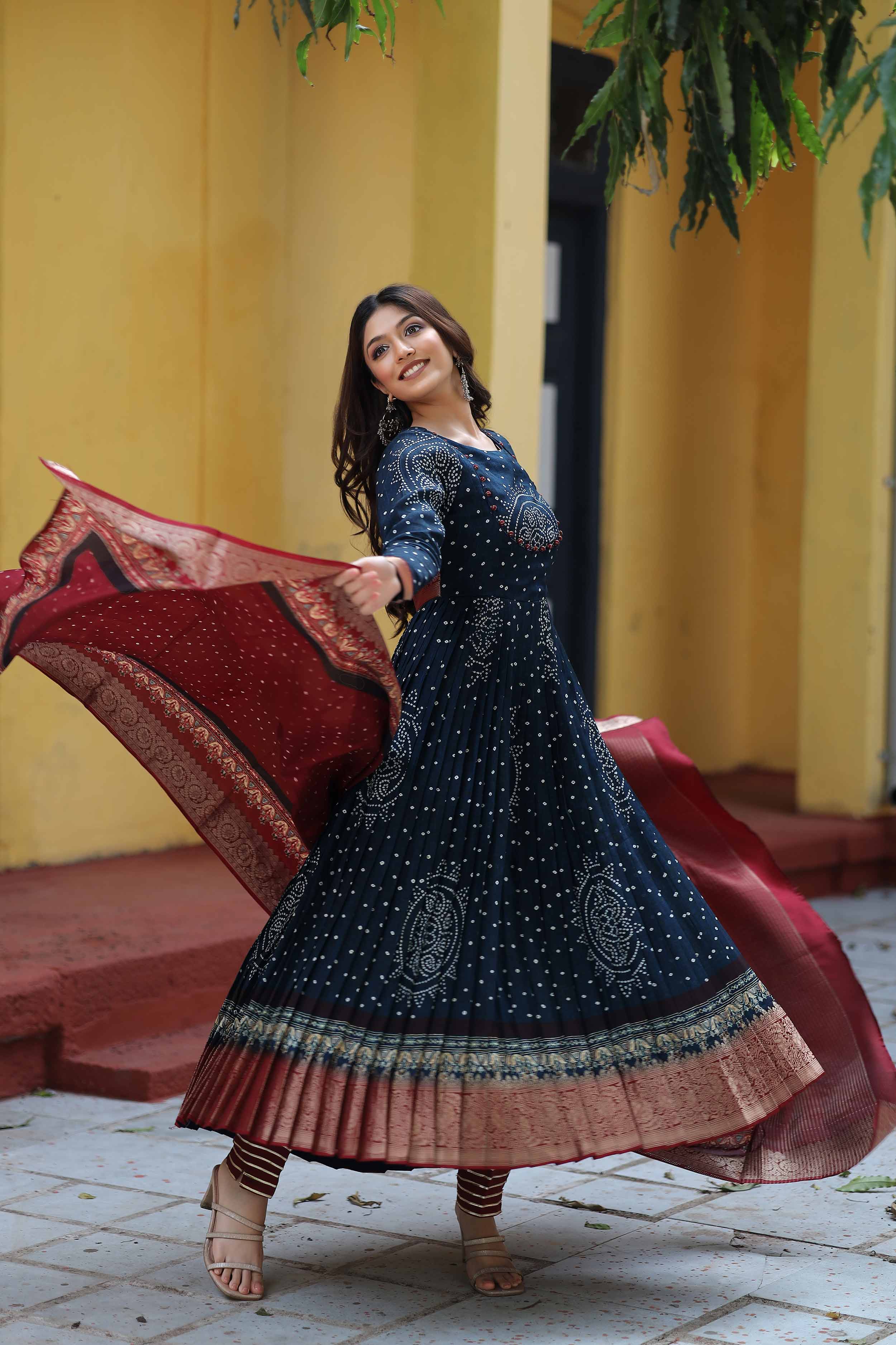 a woman in navy blue silk Anarkali suit