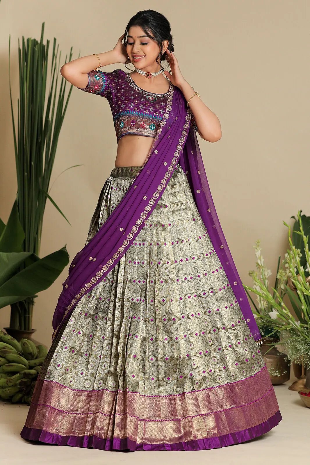 Model posing in Shreshtha purple lehenga, elegant style