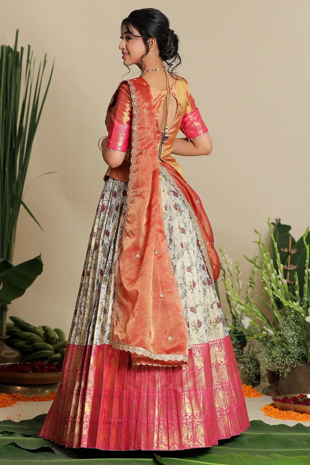 Back view of ivory and pink half saree lehenga set