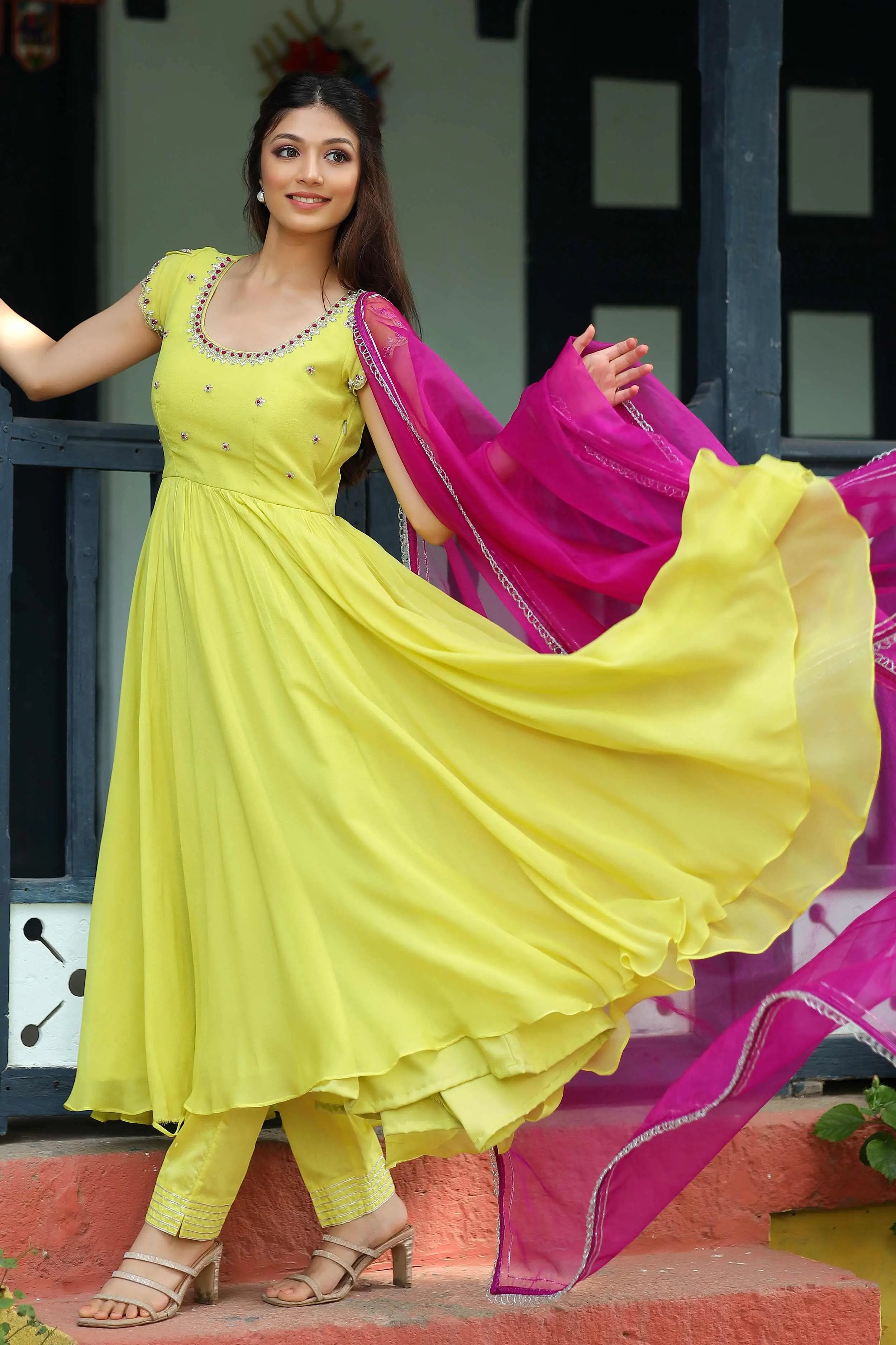 a woman in yellow dress and pink dupatta