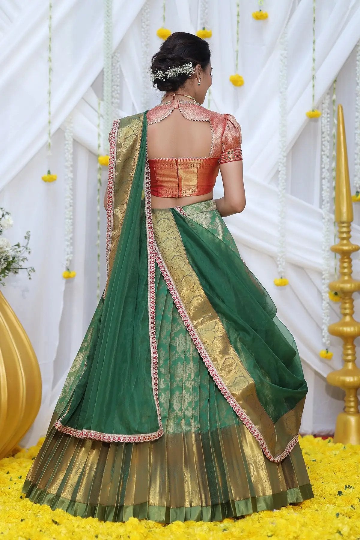 a woman in green half saree