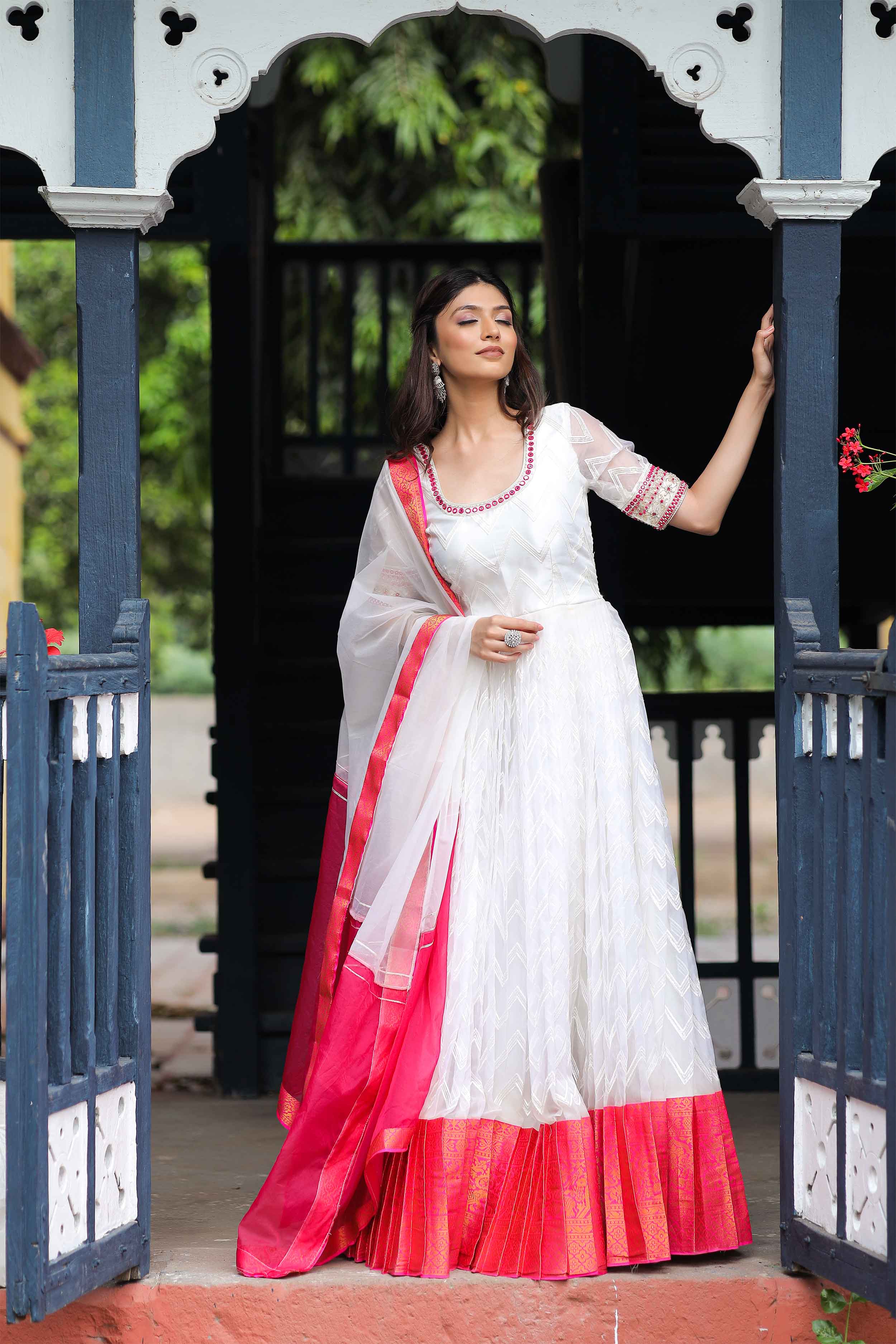 a woman in White dress and red dupatta 