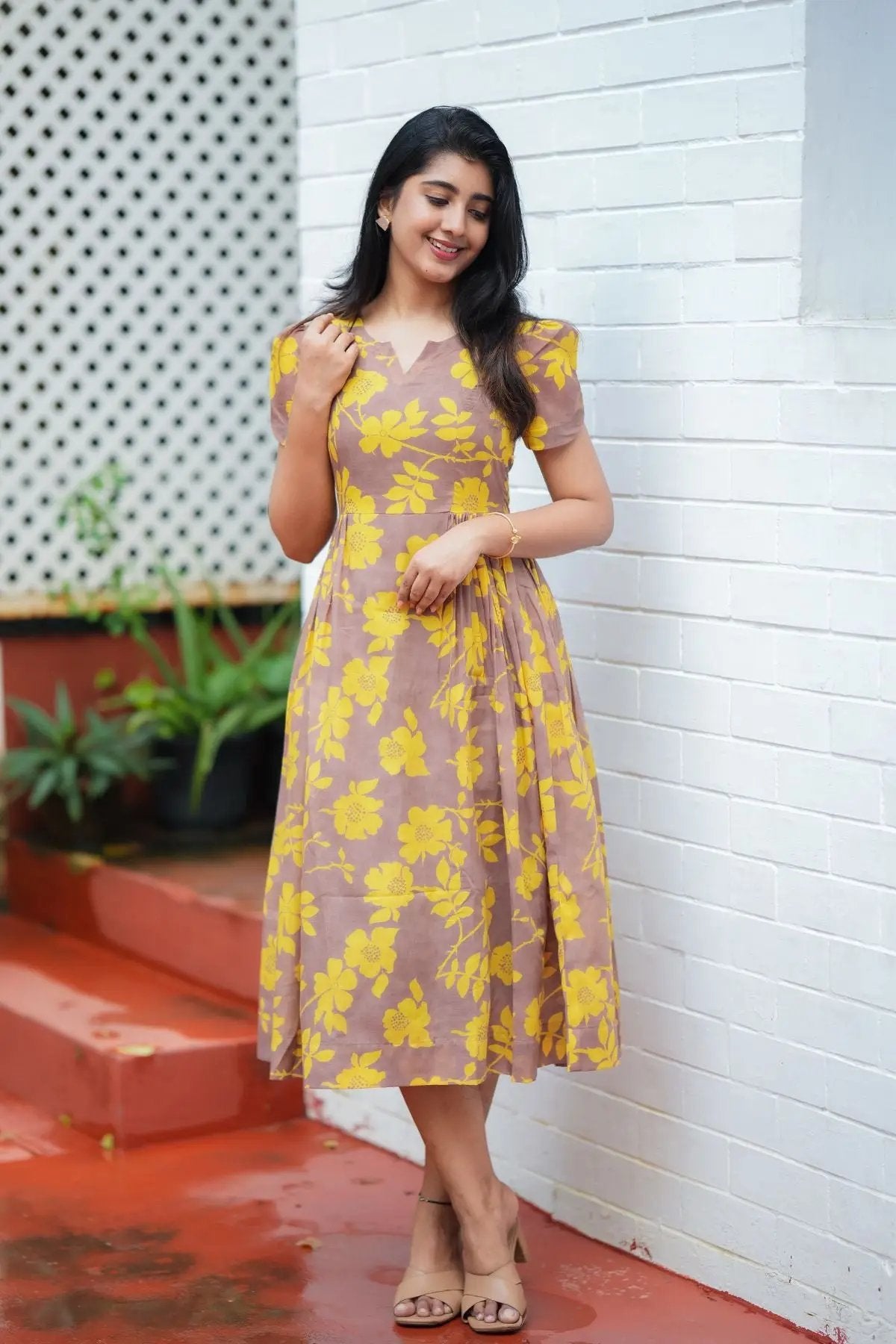 Model wearing Yelena Midi Dress with yellow floral prints, styled as a kurta and suit set for casual or festive occasions.