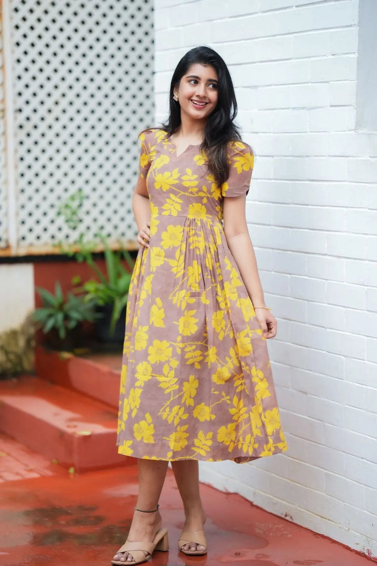 Yelena Midi Dress in yellow floral print, styled with puff sleeves and pleats, ideal for summer and casual outings.