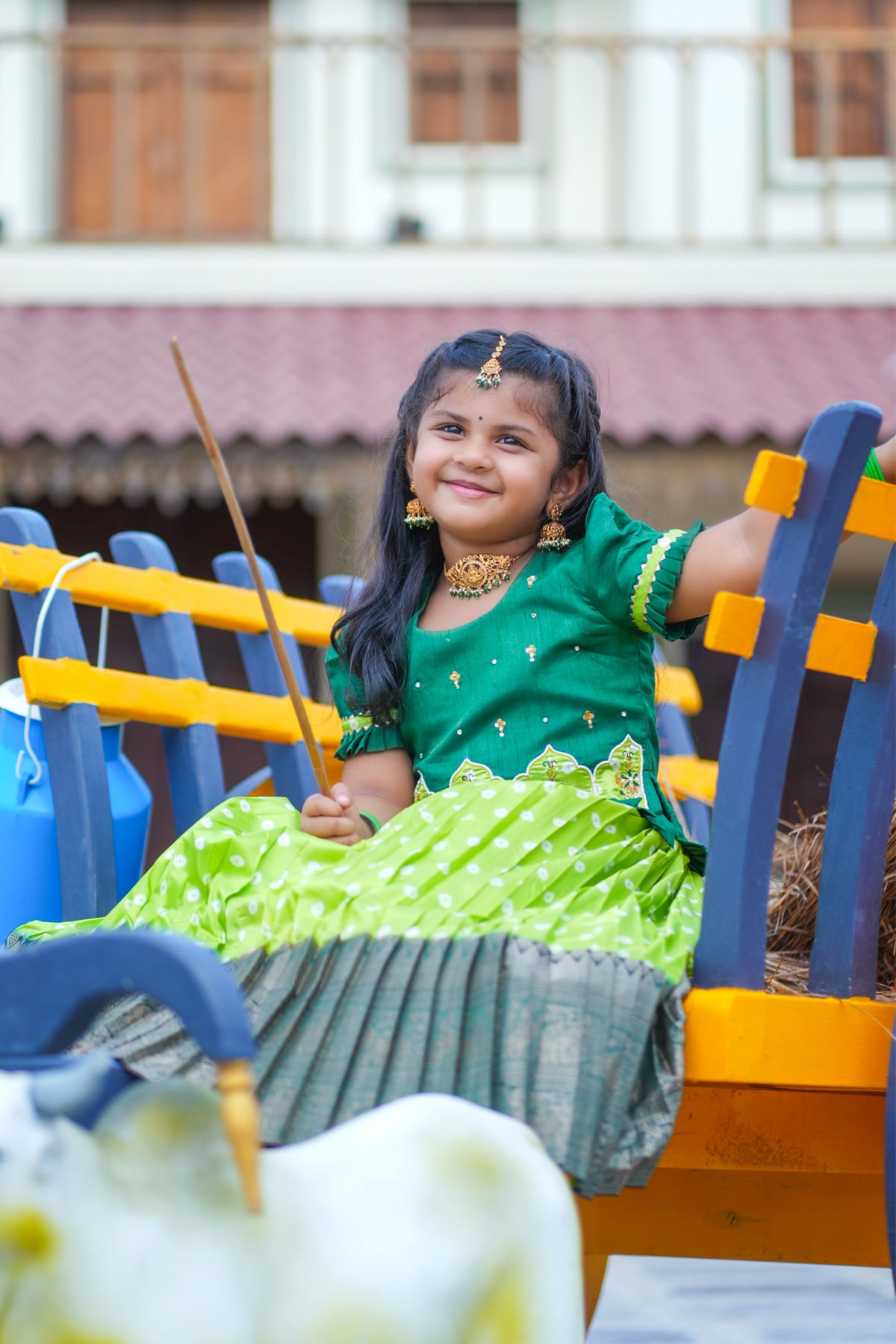 Girl in light sea green lehenga on a colorful bench