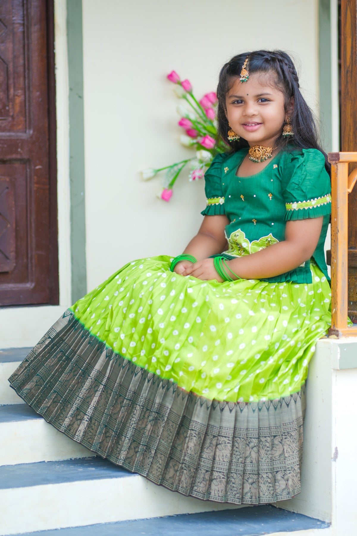 Girl in light sea green lehenga sitting on steps