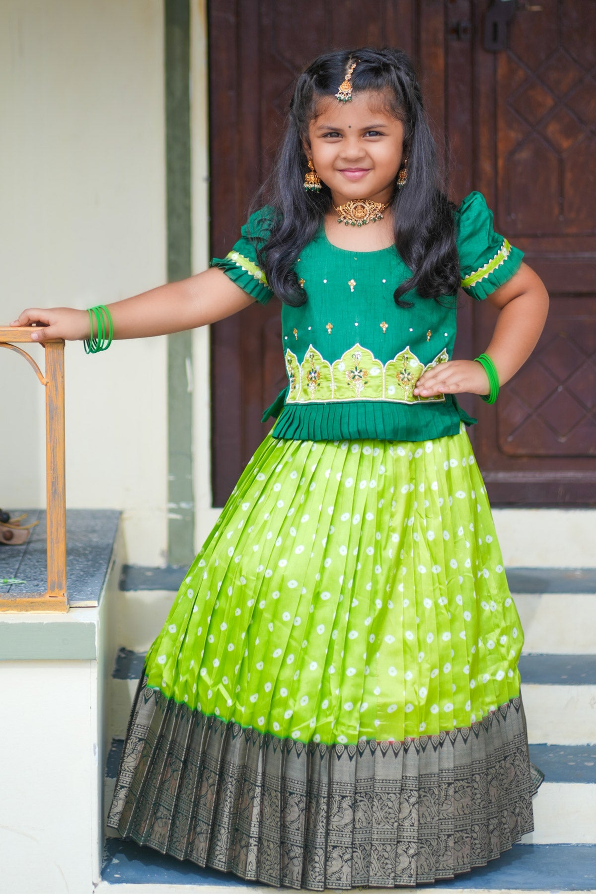 Girl in light sea green lehenga standing by door