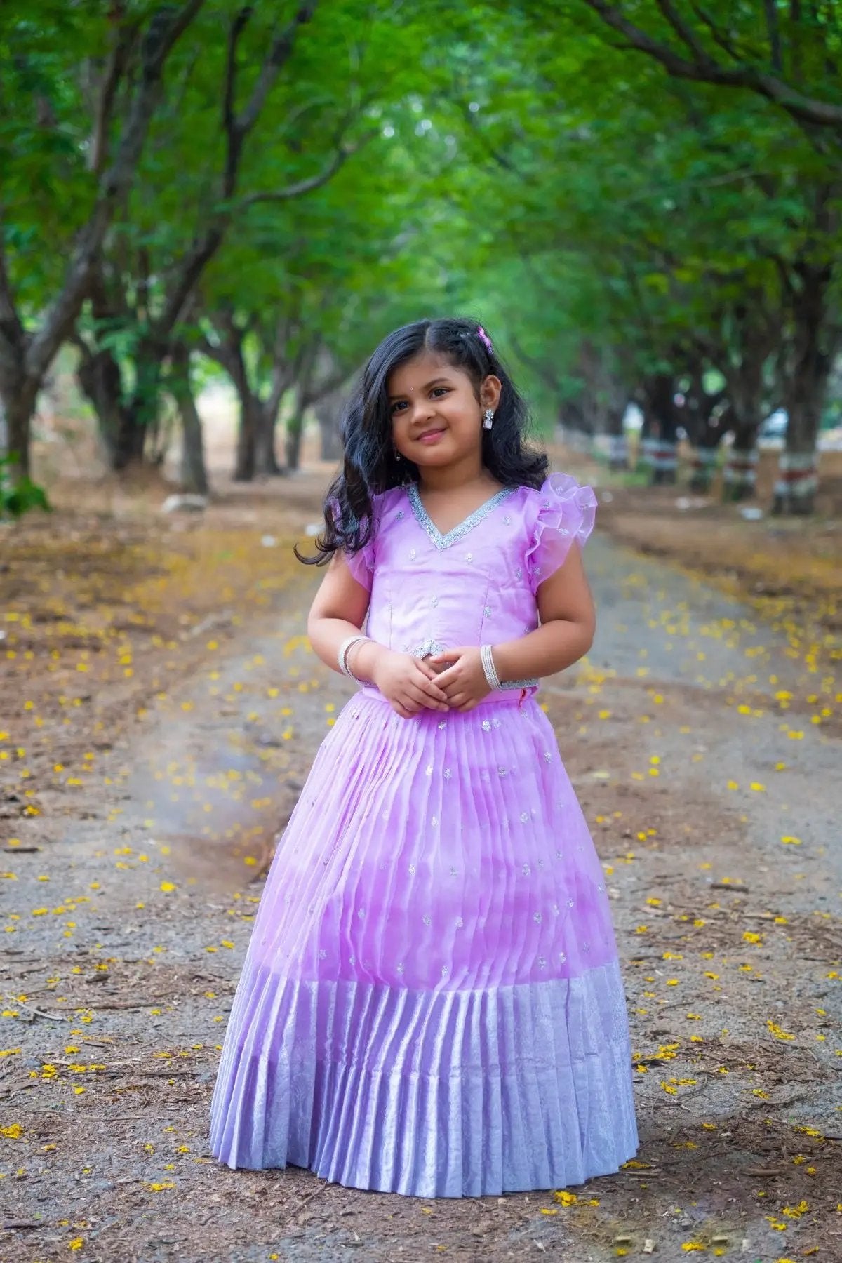 Child wearing lavender Baby Siddhi Lehenga Set in nature