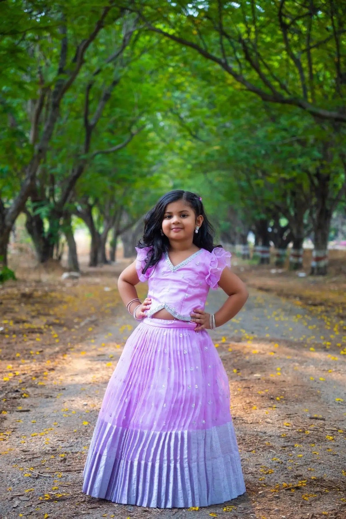 Lavender Baby Siddhi Lehenga Set worn by a girl in a wooded area