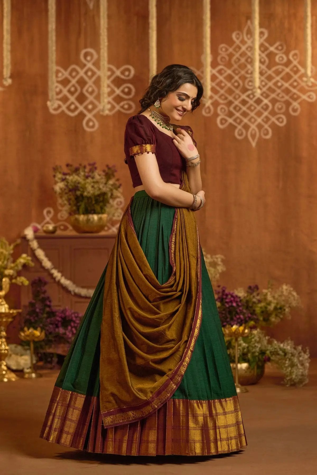 Side profile of Devara Handloom Lehenga Set in Green featuring maroon blouse, gold border, and traditional draping style.