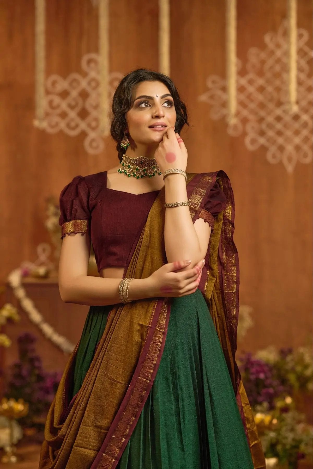 Close-up of Devara Handloom Lehenga Set in Green with maroon blouse, intricate gold border, and elegant traditional styling.