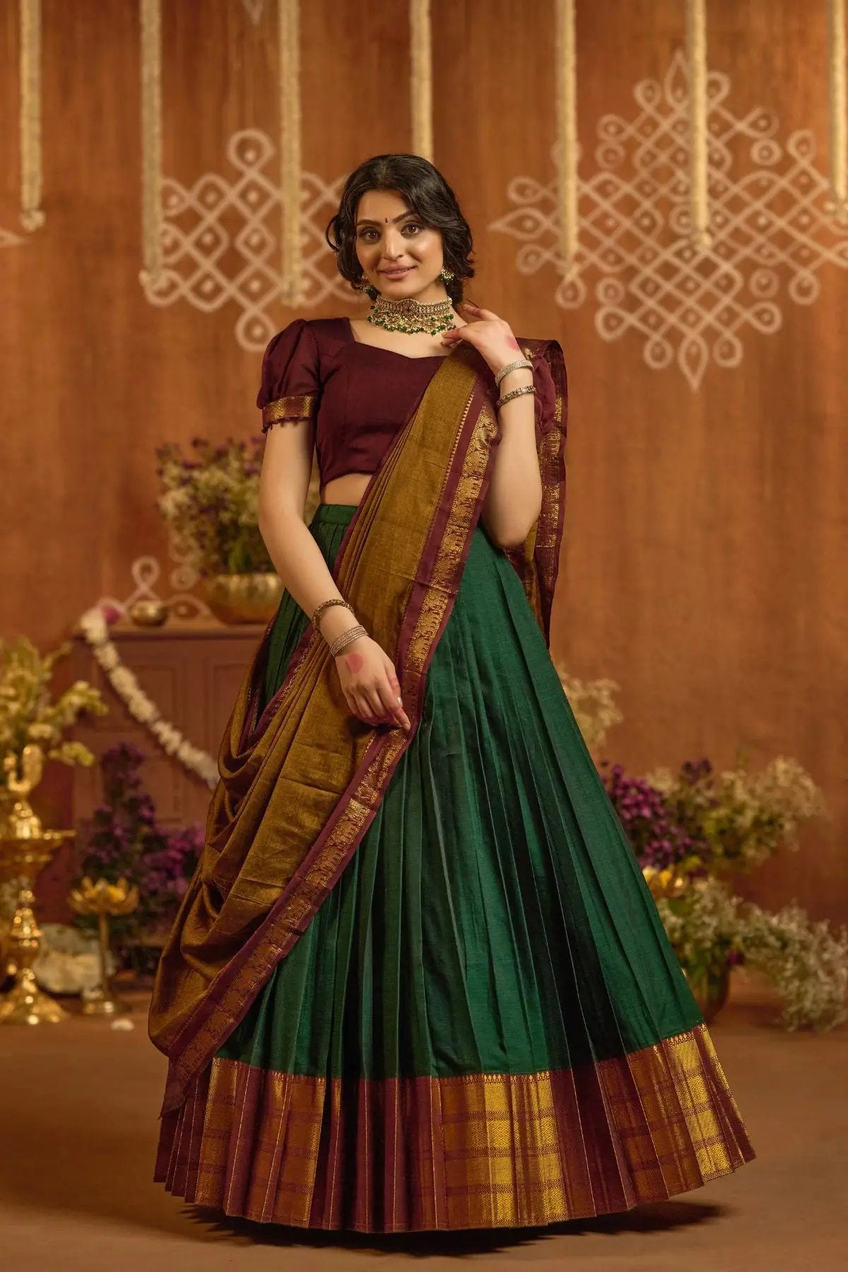 Front view of Devara Handloom Lehenga Set in Green with maroon blouse, gold border, and pleated design for ceremonial occasions.