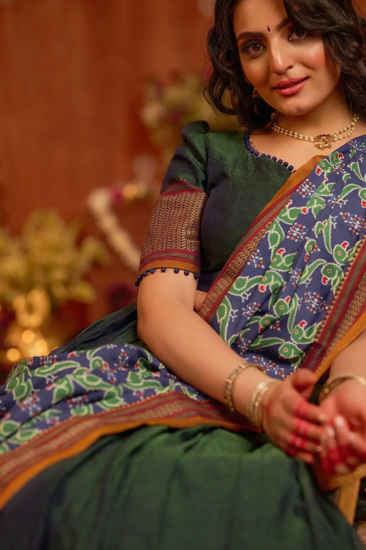 Close-up of Dhiwija Handloom Lehenga Set in peacock green, showcasing detailed embroidery and vibrant colors in a traditional style.