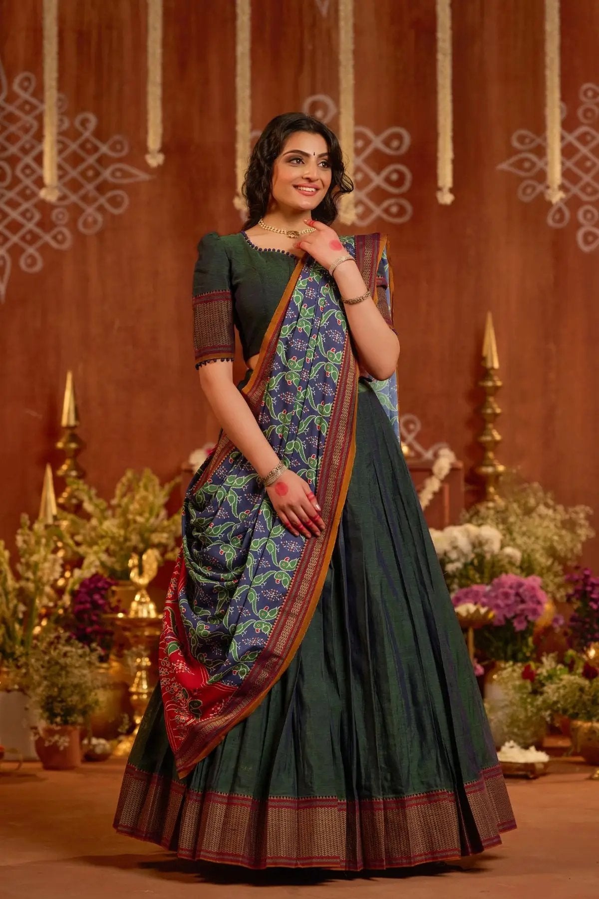 Dhiwija Handloom Lehenga Set in dual-tone peacock green with intricate patterns and traditional design, styled in an elegant setting.