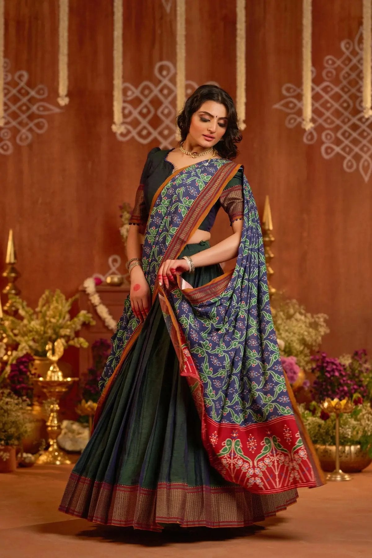 Traditional Dhiwija Handloom Lehenga Set in peacock green with a dual-tone dupatta featuring intricate designs, ideal for festive wear.