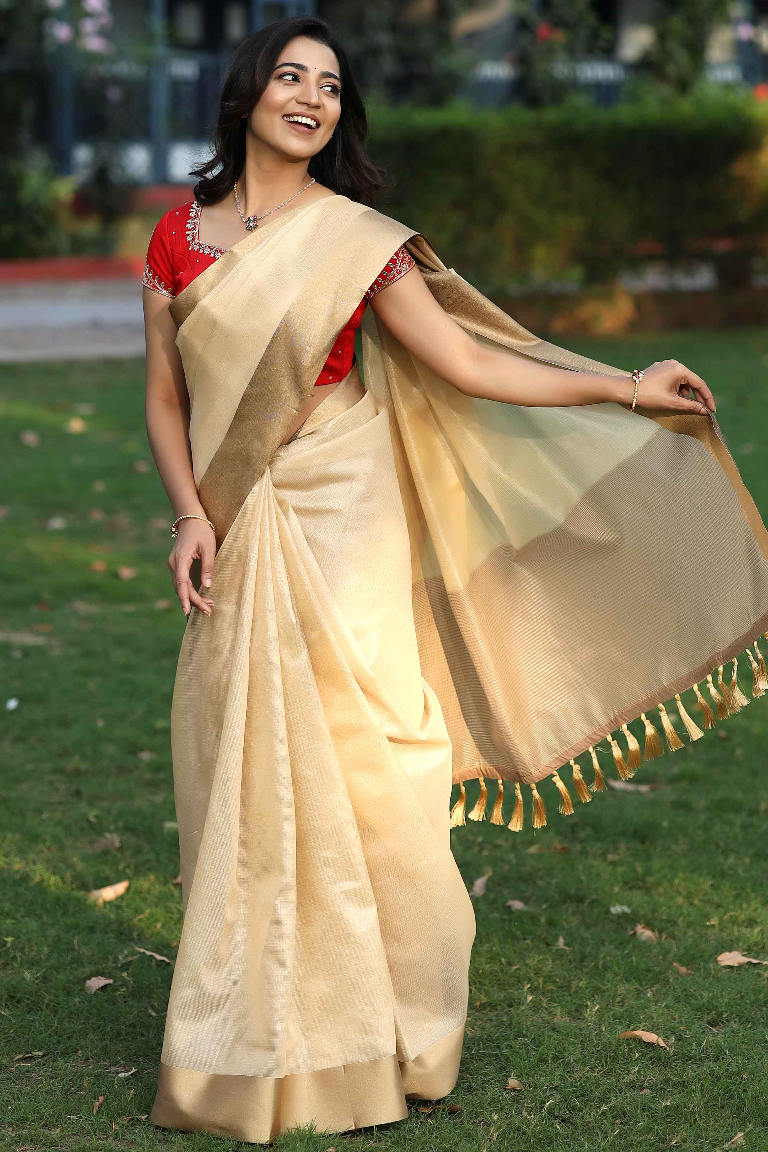 Pavitra Onam Kota Zari Saree in golden and red 