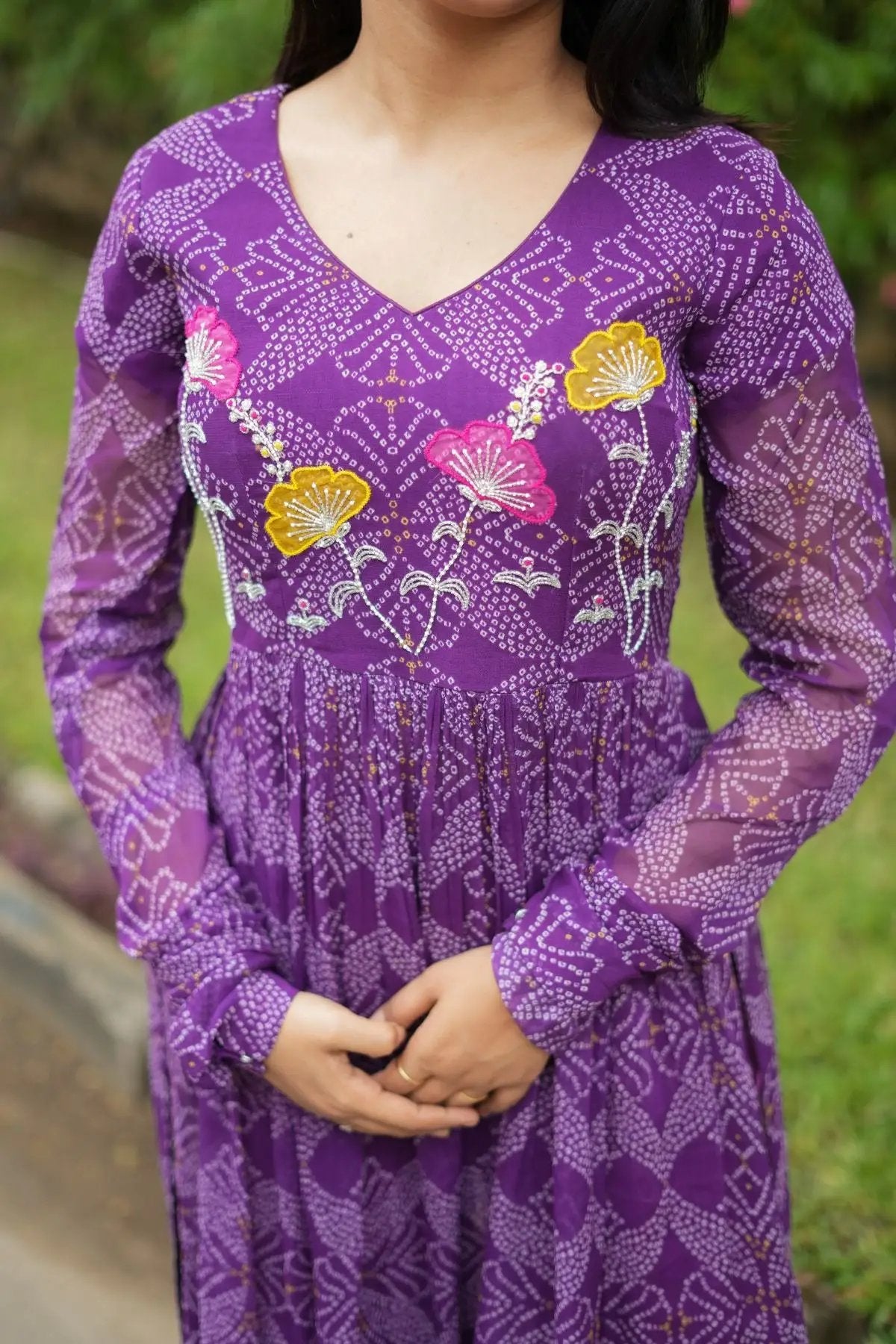 Close-up of the Panna Bandhej Kurta Set in purple, showcasing intricate floral applique embroidery on the bodice, ideal for festive and wedding occasions.