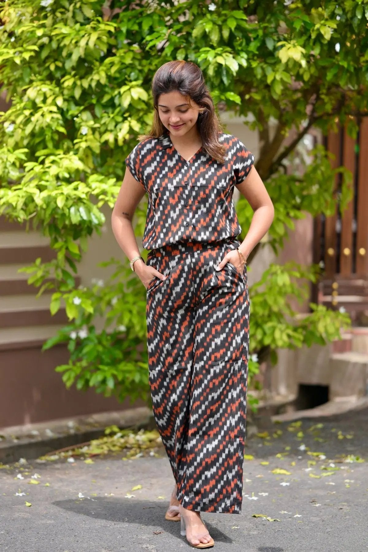 Woman in patterned outfit walking outdoors