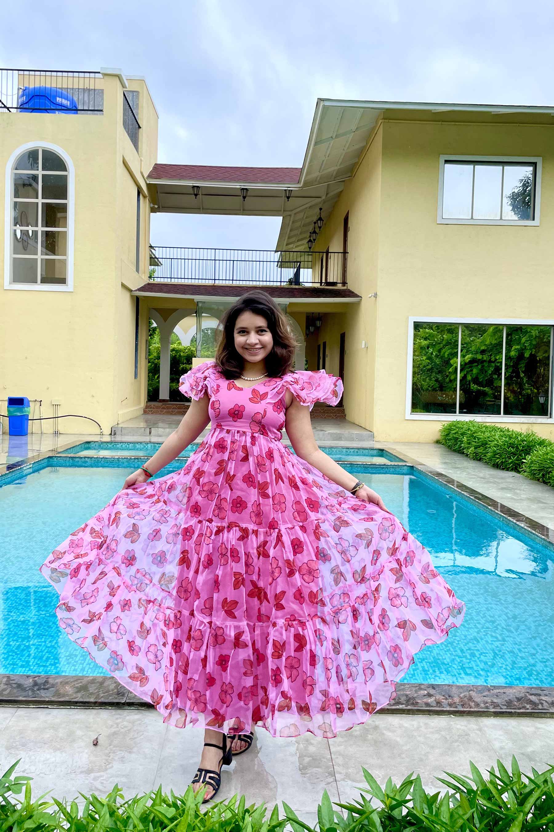 Girl in pink organza dress by poolside